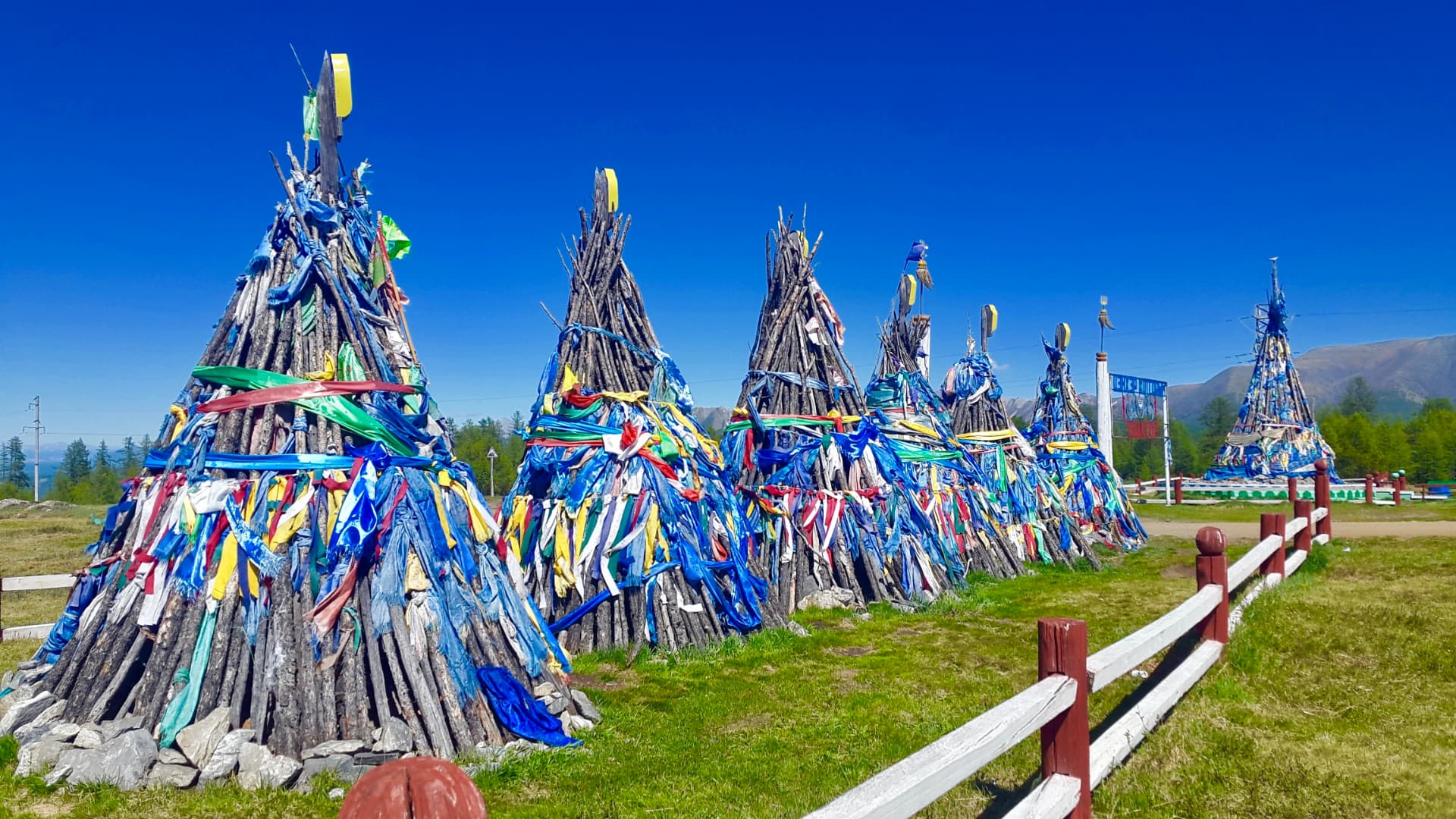Sacred ovoo shrines wrapped in prayer scarves